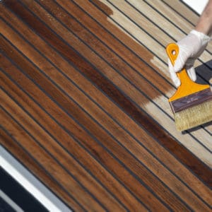 Deks Olje D1 being applied to a boat deck with a brush
