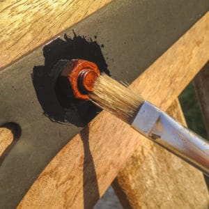 Owatrol Oil being applied to rusted nut with a brush