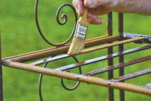 Owatrol Oil being applied to a garden bench