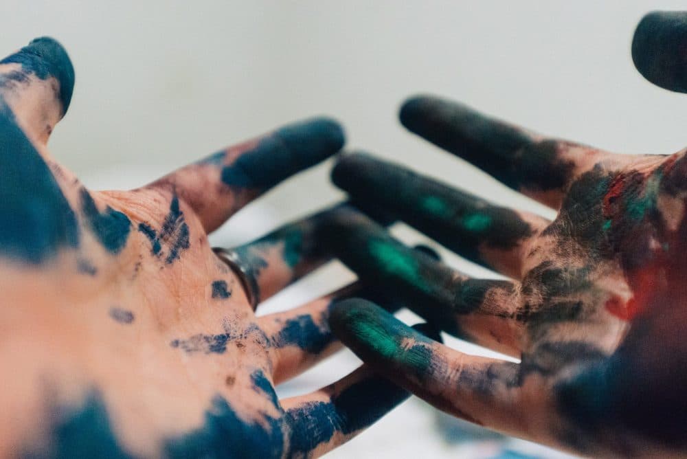 Hands covered in paint