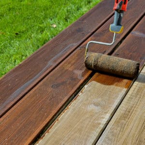 Textrol being applied to a deck with a roller